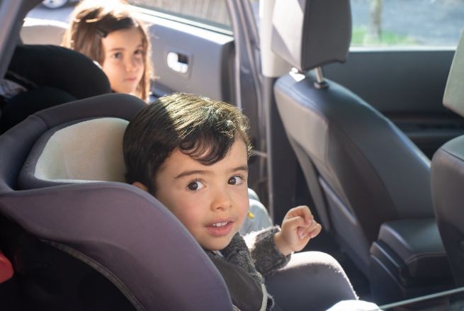 Children in back seat of a car.