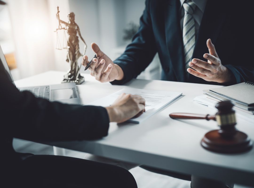 Attorney and client sitting at a table discussing injury case.