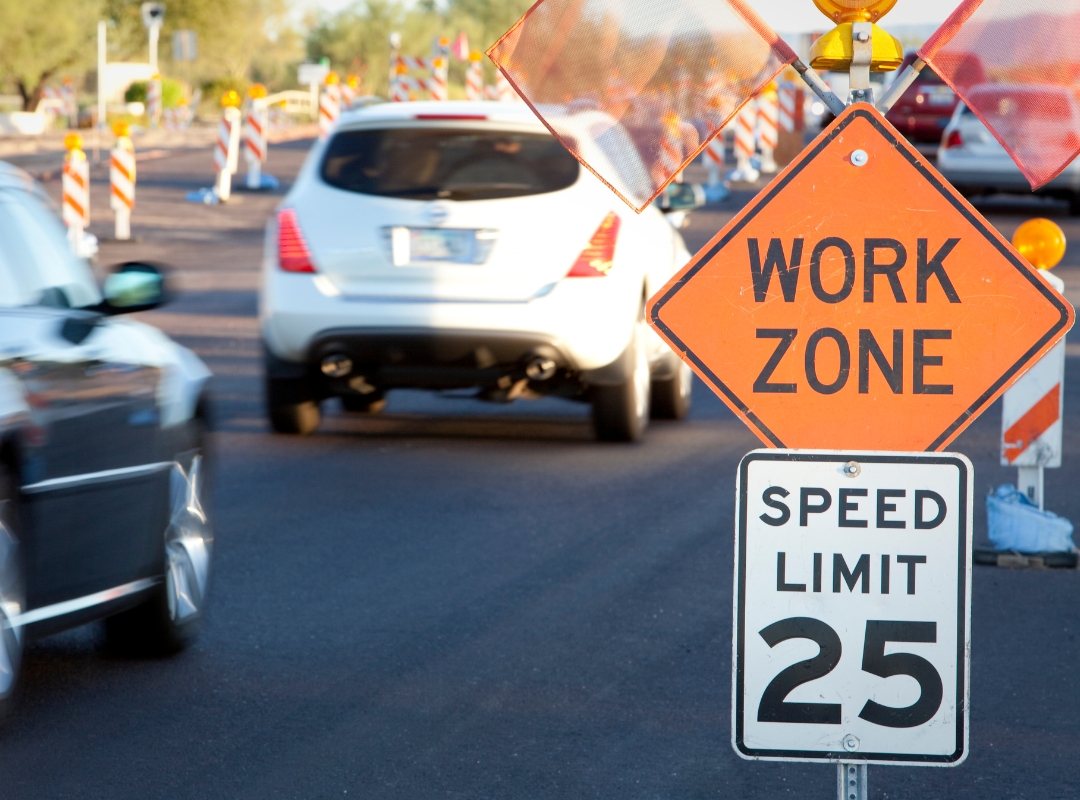 Vehicles driving in a work zone.