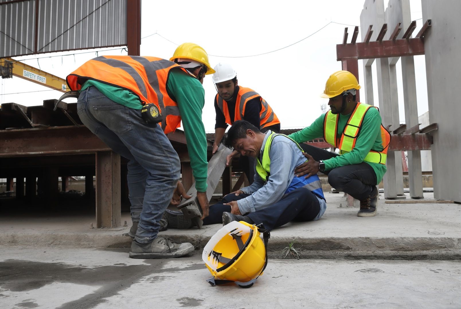 Construction workers helping someone who was hurt on the job.