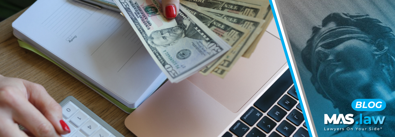 Woman counting money with a calculator