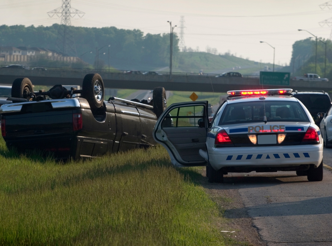 Police vehicle at the scene of a car accident.