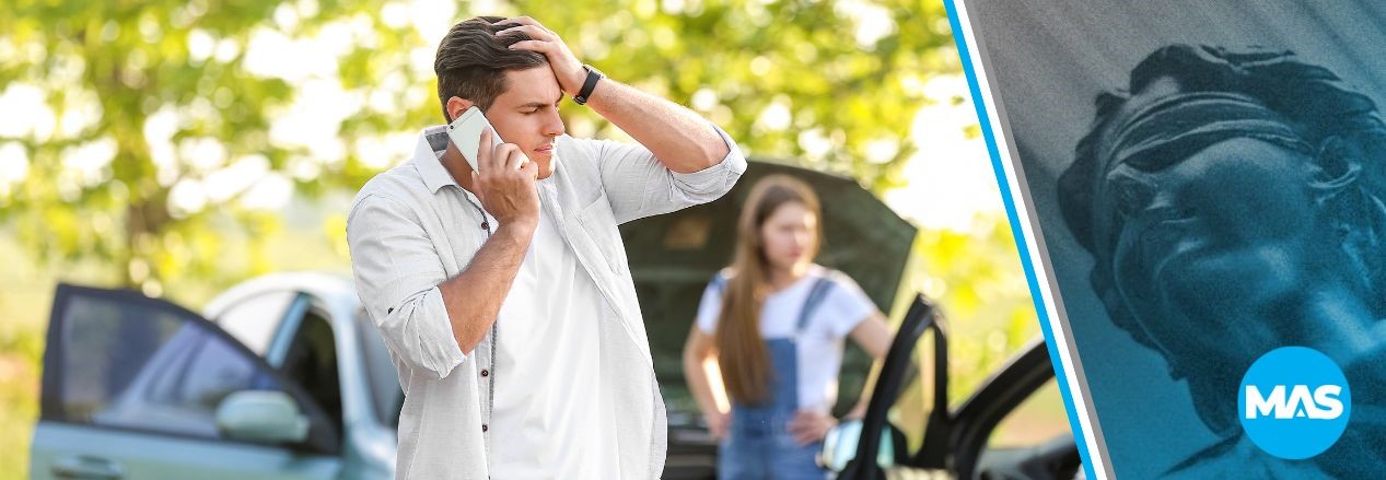 Man talking on the phone after a car accident.